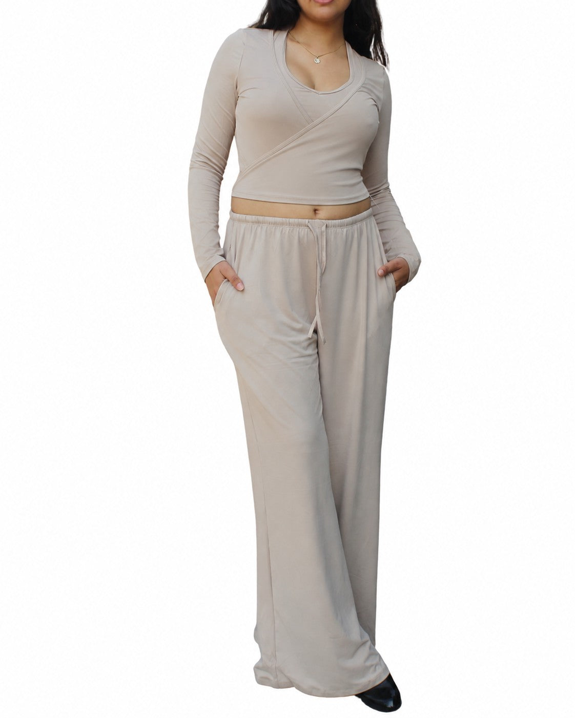 A woman wearing a PalkiMarketPlace beige long-sleeve wrap crop top and matching wide-leg lounge pants with pockets.